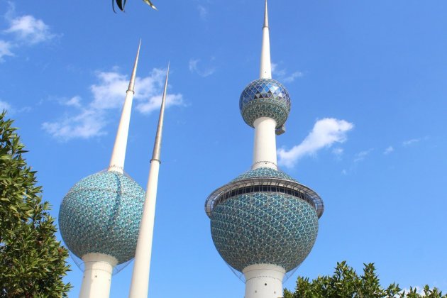 A white-green building under a blue sky.