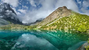 Tourism in Tajikistan, lake in the Fan Mountains. Scenic summer view, panorama landscape.