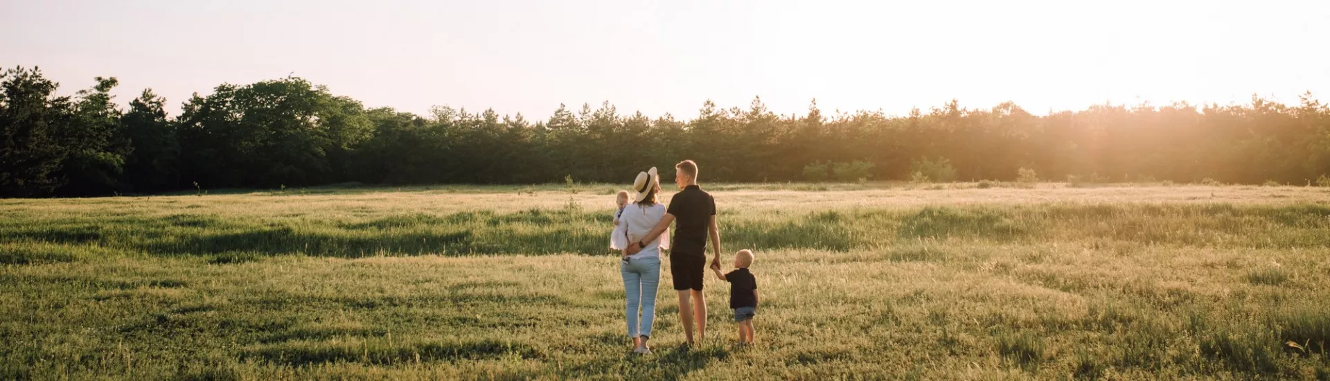 family walking on green grass field during daytime