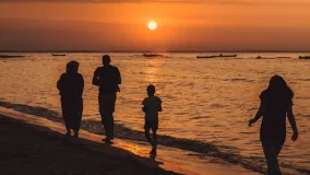 Family on the beach at the sunset